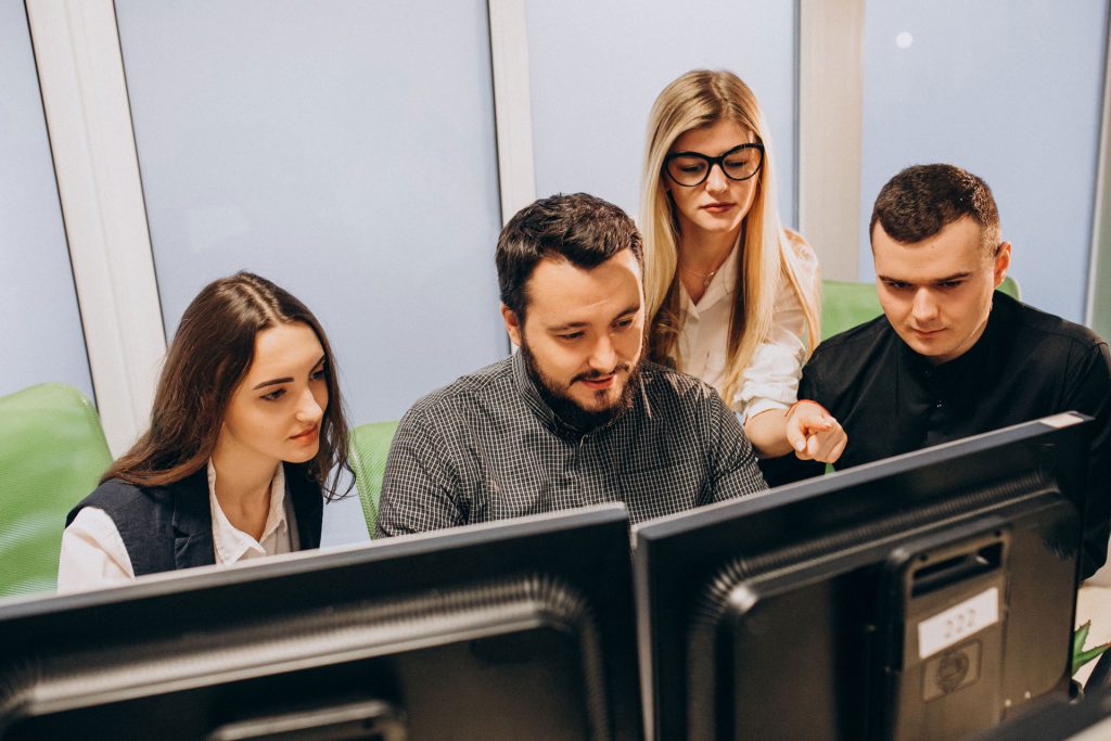 Staff Augmentation - Team reviewing work on a computer