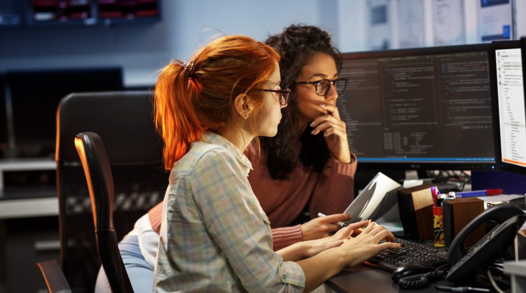 Two women software engineers looking at their screens