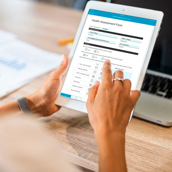 Close up of a woman's hands filling out a form on a tablet