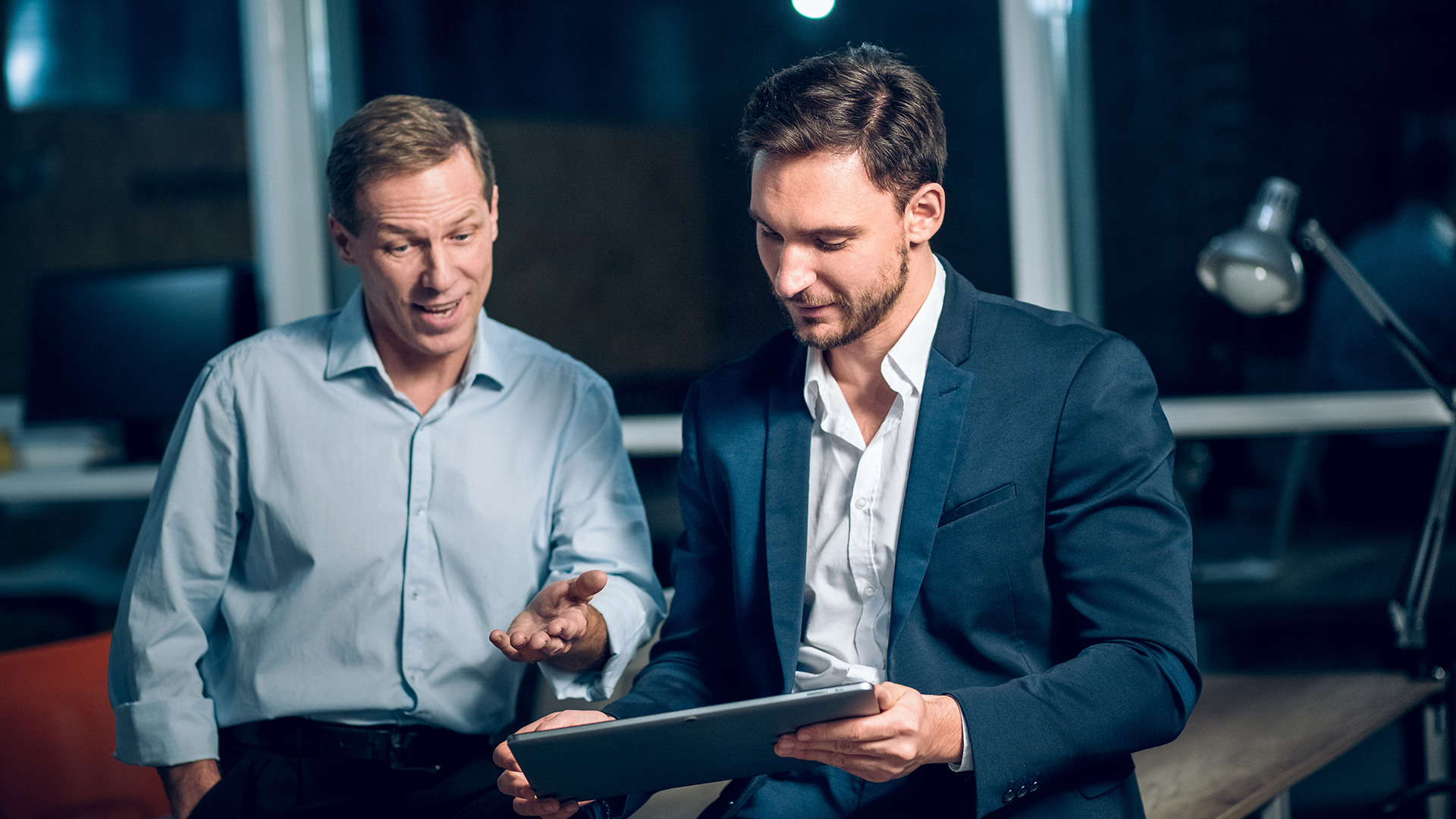 2 guys working in a tablet